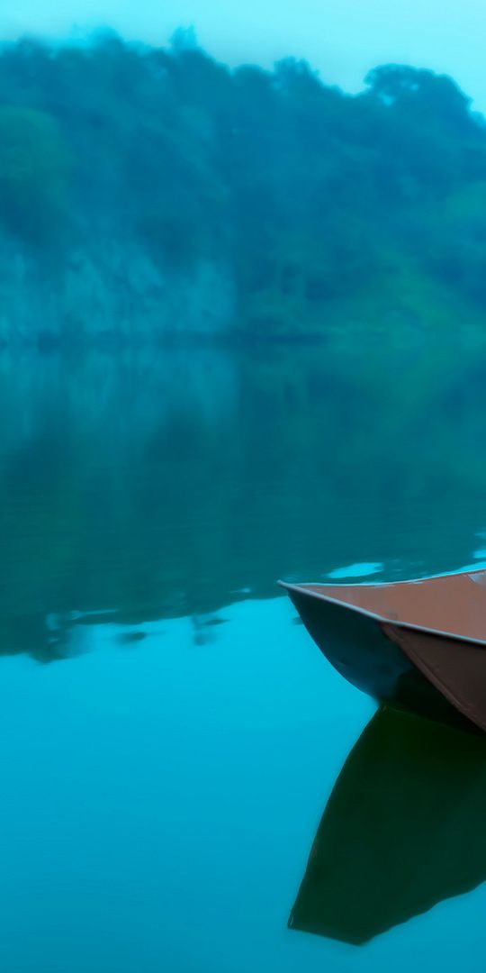 Beautiful Brunette Woman in a Colorful Dress on a Tranquil Lake