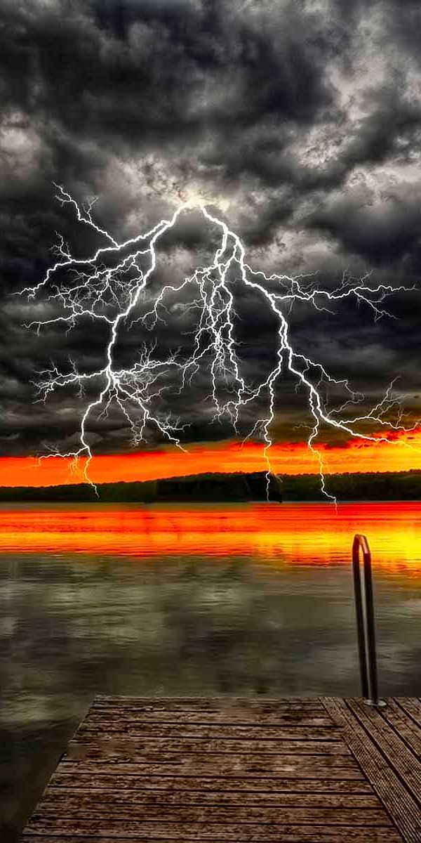 Breathtaking Ultra HD mobile wallpaper featuring a sunset and lightning over a lake