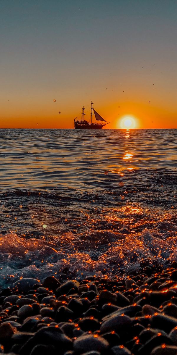 Breathtaking Sunset at the Shore with a Ship