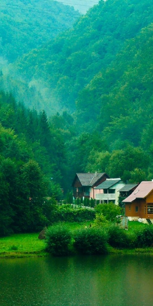 Breathtaking Green Landscape with Cozy Houses by the Lake
