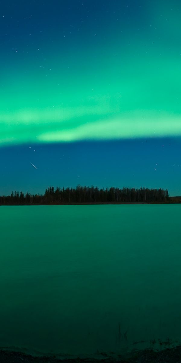 Breathtaking Aurora Borealis Over Calm Waters at Night