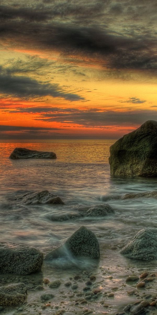 Breathtaking Sunset Over Rocky Shoreline - Perfect Mobile Wallpaper