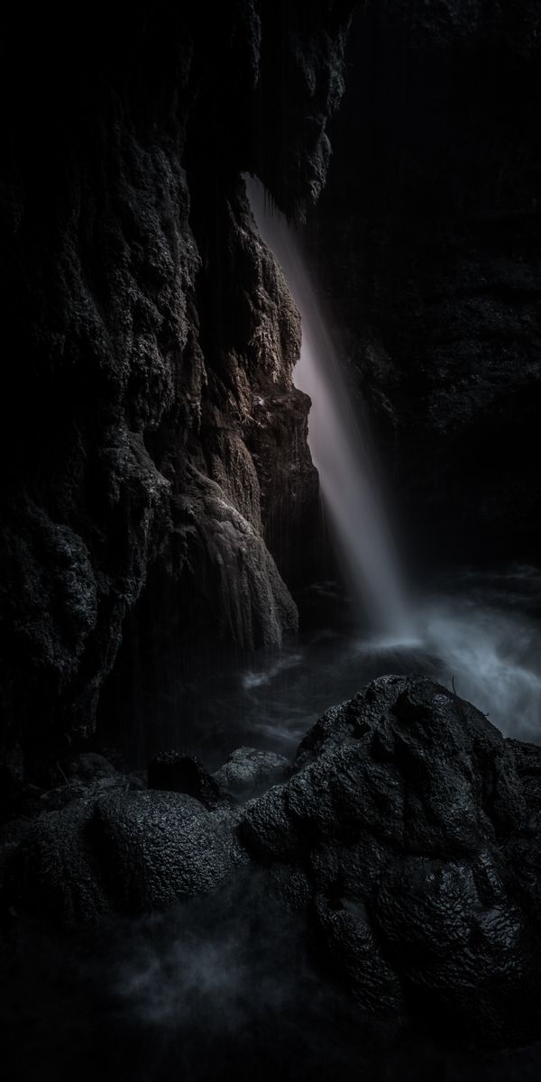 Dark Waterfall in a Cave - A Breathtaking Nature Scene