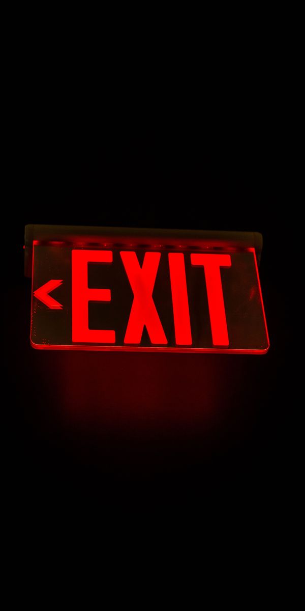 Ultra HD Red EXIT Sign with Backlight on Dark Background
