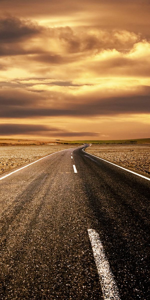 Scenic Desert Road at Sunset with Dramatic Clouds