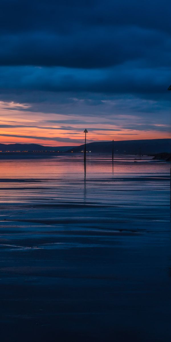 Captivating sunset wallpaper featuring clouds, sea, and twilight hues