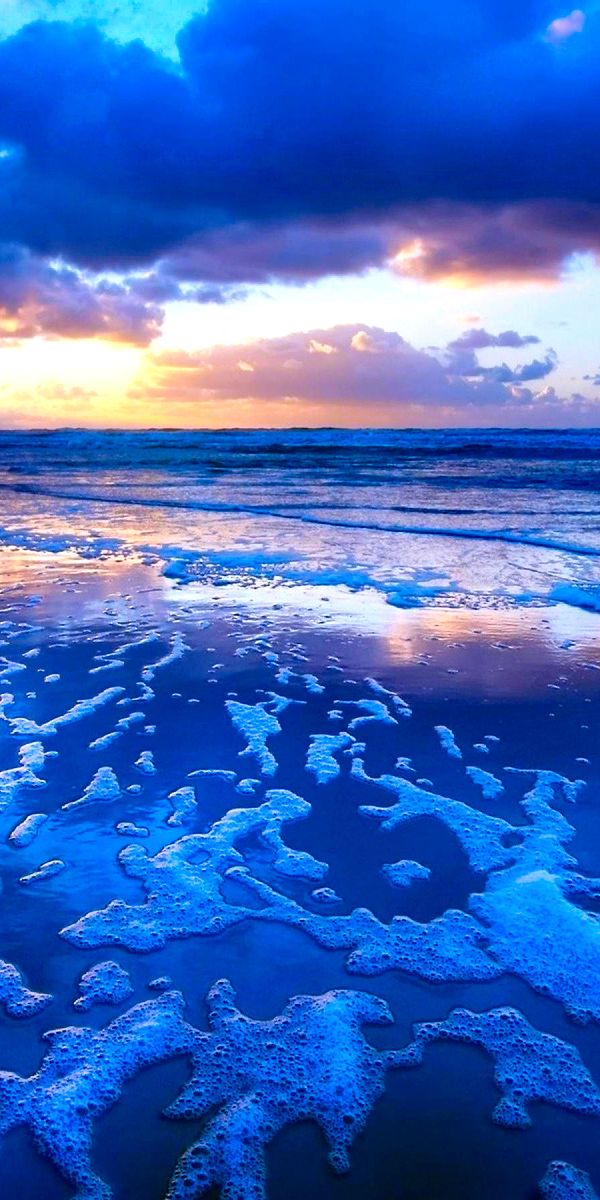 Breathtaking beach sunset phone wallpaper with vibrant colors and waves