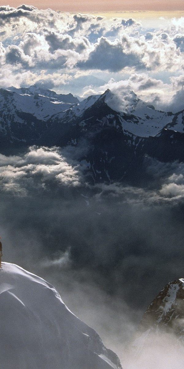 Epic mobile wallpaper of extreme climbing in the Swiss Alps with clouds