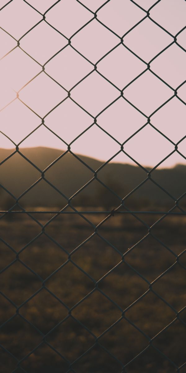 High-Quality Nature Sunset Through a Chain Link Fence