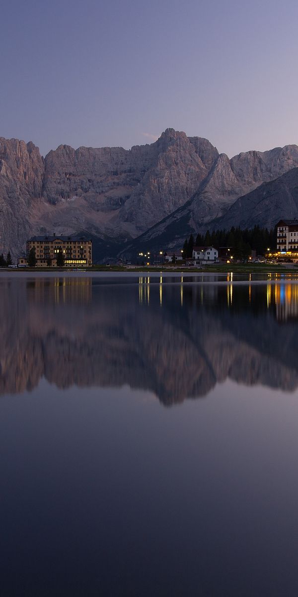 Breathtaking mobile wallpaper of a tranquil lake reflecting mountains at sunset
