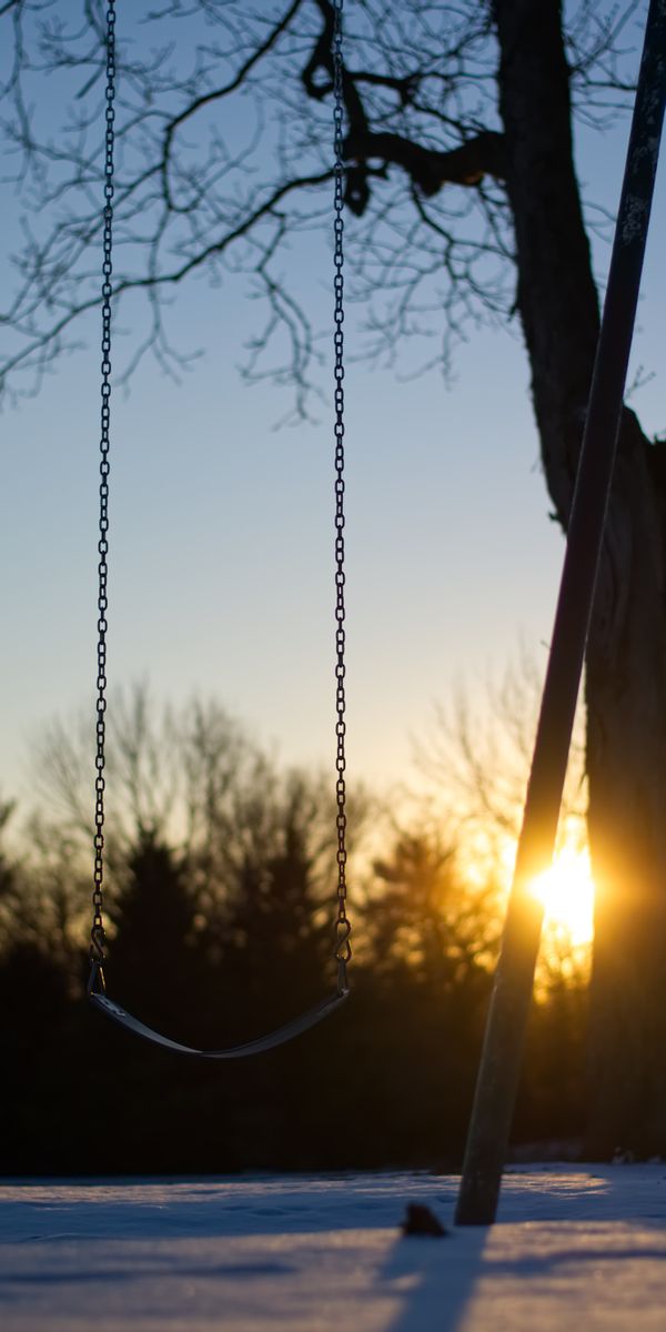 Tranquil sunset scene with swing and winter trees - perfect phone background