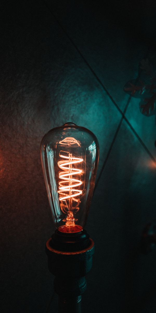 Vintage Light Bulb with a Spiraling Glow - Perfect Mobile Wallpaper